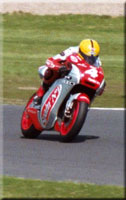 Roberto Rolfo Honda wearing a Joey          Dunlop replica helmet.